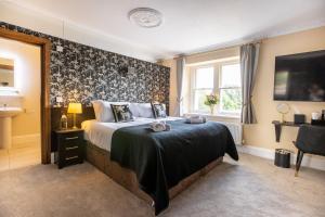 a bedroom with a large bed and a window at The Lighthouse Bed & Breakfast in Frome
