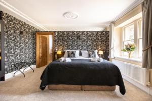 a bedroom with a large bed with a black blanket at The Lighthouse Bed & Breakfast in Frome +34 photos