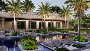 a resort with a swimming pool and palm trees at Taj Pushkar Resort & Spa, Rajasthan in Pushkar