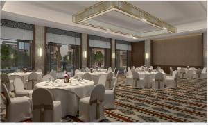 a banquet room with white tables and white chairs at Taj Pushkar Resort & Spa, Rajasthan in Pushkar