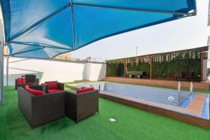 a large blue umbrella over a swimming pool at Luxury 2BR Oasis in Lekki