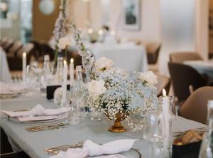 a table with a vase of flowers and candles at Hotel Aro Palace in Braşov