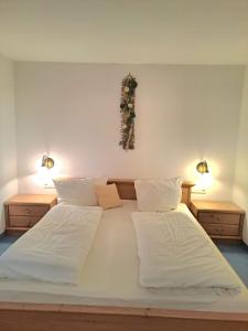 a bedroom with two beds and two lights on the wall at Bäuerlehof in Seebach