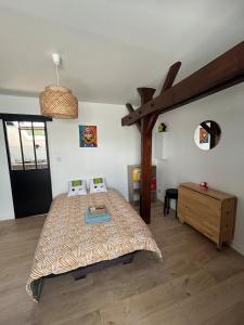 a bedroom with a bed and a wooden floor at Super Mario Studio ! in Jaunay-Clan