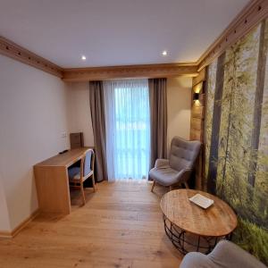 a room with a desk and a table and chairs at Bäuerlehof in Seebach +14 photos
