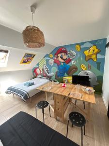 a bedroom with a mural of a mario room at Super Mario Studio ! in Jaunay-Clan
