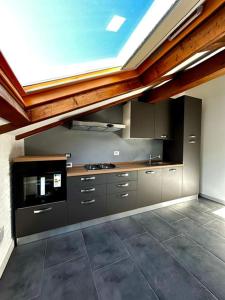 a large kitchen with a skylight in the ceiling at CARDAHAUSe Via DANTE 12 in Cogliate