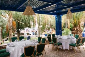 a group of tables and chairs in a garden at Rive Du Lac in Lalla Takerkoust +224 photos