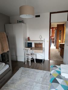 a bedroom with a desk with a chair and a bed at Bel Appartement panoramique in Arâches-la-Frasse