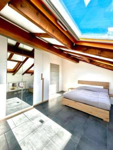 a bedroom with a bed and a large window at CARDAHAUSe Via DANTE 12 in Cogliate