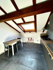 a kitchen with a table and chairs and a stove at CARDAHAUSe Via DANTE 12 in Cogliate +9 photos