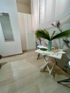 a living room with a table with a plant on it at B&B Tribale in Ercolano