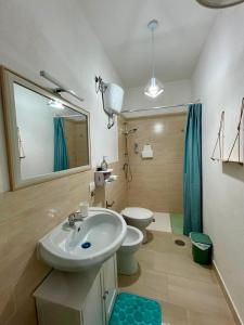 a bathroom with a sink and a toilet and a mirror at B&B Tribale in Ercolano