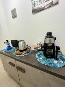 a kitchen counter with a coffee maker on a counter top at B&B Tribale in Ercolano +27 photos