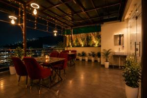 a dining room with a table and chairs at Sunburry Hotel Tapovan Rishikesh in Narendranagar