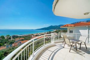 a balcony with chairs and a view of the ocean at Hotel Smaragdi in Chrysi Ammoudia