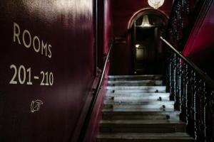 a staircase in a building with the words rooves on the wall at Eurostars Josefine in Vienna
