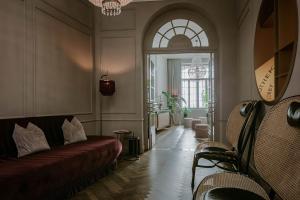 a living room with a couch and a window at Eurostars Josefine in Vienna +92 photos