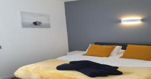 a bedroom with two beds with yellow pillows at South Beach Kings Promenade Hotel in Blackpool +65 photos