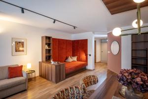 a living room with a bed and a couch at Apart Denise in Fügen