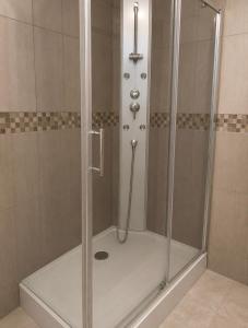 una doccia con porta in vetro in un bagno di Worgot a Monthermé