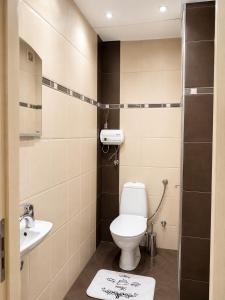 a bathroom with a toilet and a sink at Hotel Topalovi in Nesebar +28 photos