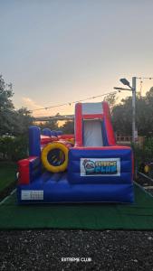 a inflatable bounce house on a field with a bounce at extreme park in Deir Ḥannā