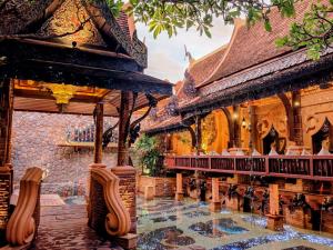 a building with a swimming pool in front of it at Sawasdee Village in Kata Beach