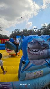 a person standing on an inflatableinosaur at extreme park in Deir Ḥannā +6 photos