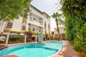 a swimming pool in front of a building at Riad Salt River in Martil