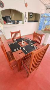 a wooden table with two chairs and a table with a table at Secret Garden Beach Hotel in Trincomalee +102 photos