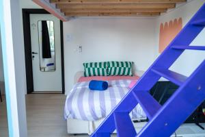 a bedroom with a bed with a blue ladder at Cool Cool House in Liège