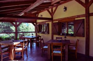 a dining room with wooden tables and chairs at House of Aurora in Šwidnik