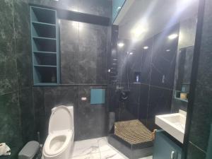a bathroom with a toilet and a sink at Afsona in Namangan