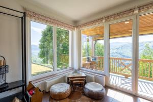 a room with large windows with a view at Utopia Mountain resort Bjelasnica in Bjelašnica