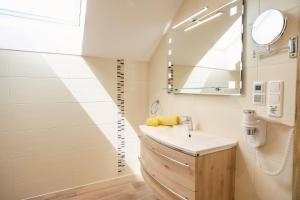 a bathroom with a sink and a mirror at Altroiterhof in St. Wolfgang