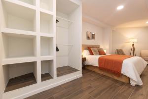a bedroom with a bed with white shelves at Xena Pueyo by BeValle in Panticosa