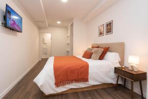 a bedroom with a bed and a tv on a wall at Xena Pueyo by BeValle in Panticosa