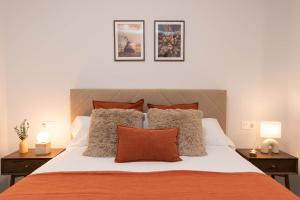 a bedroom with a large bed with two lamps at Xena Pueyo by BeValle in Panticosa