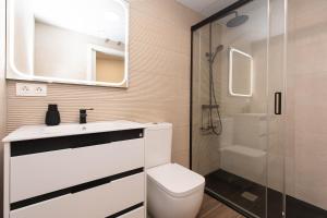 a bathroom with a toilet and a sink and a shower at Xena Pueyo by BeValle in Panticosa