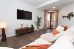 a living room with a couch and a tv on the wall at Xena Pueyo by BeValle in Panticosa +22 photos