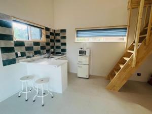 a small kitchen with a sink and a staircase at Dara House Private Pension in Jangheung