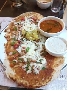 a plate of food with a pizza and a bowl of soup at Hotel Hibiscus Tree- Bachupally in Hyderabad