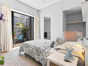 a bedroom with a bed and a large window at Himmelblau Boutique Bed and Breakfast in Cape Town