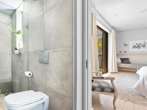 a bathroom with a white toilet and a shower at Himmelblau Boutique Bed and Breakfast in Cape Town +30 photos