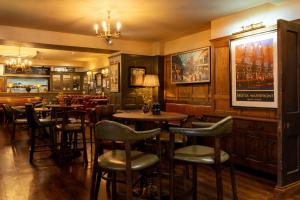 a bar with tables and chairs in a restaurant at Hort's Townhouse in Bristol