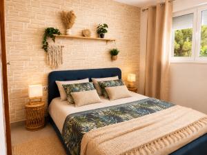 a bedroom with a bed and a brick wall at Almadrava Beach in Roses +54 photos