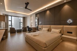 a bedroom with a large bed and a desk at Melange Hotel - Golf course road in Gurgaon +4 photos