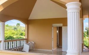 a porch with white columns and a window at Elegant Villa in Nagua with Private Pool and Jacuzzi in Nagua +40 photos