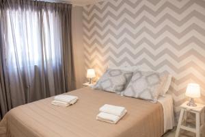 a bedroom with a bed with two towels on it at Charming House in Requião with Shared Pool in Requião